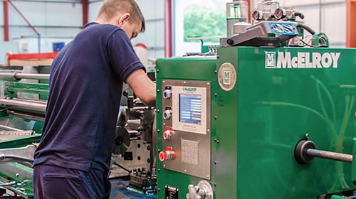 McElroy Manufacturing shop floor worker assembling equipment